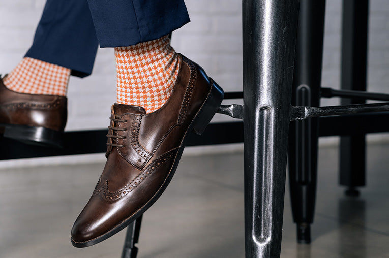 man wearing colored socks to a blue suit