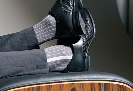 man in suit wearing grey designer dress socks made from organic cotton