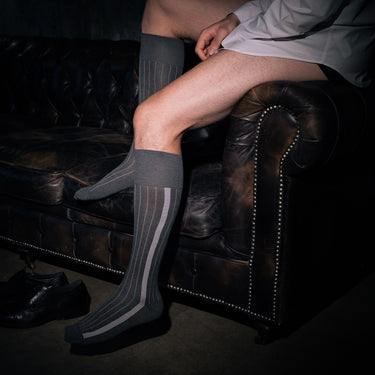 man wearing over the calf grey dress socks made from organic cotton